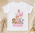 A white t-shirt with a cartoon image of a giraffe, lion, and elephant, along with a pink balloon and the name "Ronnie" printed on it.