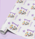 a roll of wrapping paper with a repeating pattern of elephants holding balloons and the name "Lottie" written on it.