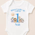 A white baby onesie with a personalized print of a cartoon animal and the text "When I wake up I will be 1 Noah" printed on it.