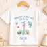 A white t-shirt with a personalized design featuring a dolphin, starfish, and other sea creatures, along with the text "When I wake up I will be Jacob" printed on it.