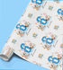 The image is a roll of wrapping paper with a repeating pattern of birthday-themed elements, including balloons, teddy bears, and the number 6.