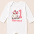 A white onesie with a cartoon image of a duck wearing a pink bow and the number 1, along with the name 'Florence' printed below.