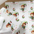 Close-up of personalised Christmas wrapping paper featuring a cute festive elf with Christmas baubles and a repeating holiday pattern on premium white gift wrap.
