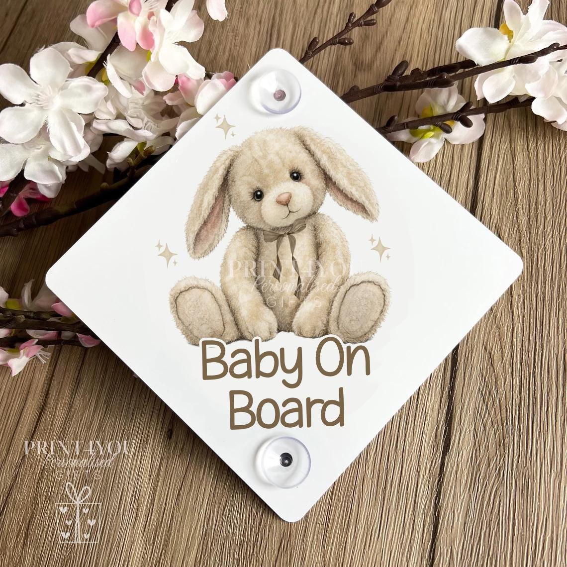 Close-up of the baby on board car sign showing the teddy bear and bunny artwork