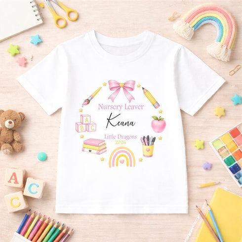 Personalised nursery leaver t-shirt featuring school themed wreath with rainbow, books, pencils, apple and custom child name, nursery name and year