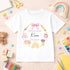 Personalised nursery leaver t-shirt featuring school themed wreath with rainbow, books, pencils, apple and custom child name, nursery name and year