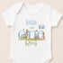 A white baby onesie with a design featuring two rabbits and balloons, along with the text "Today I am one" and "Rory" printed on it.