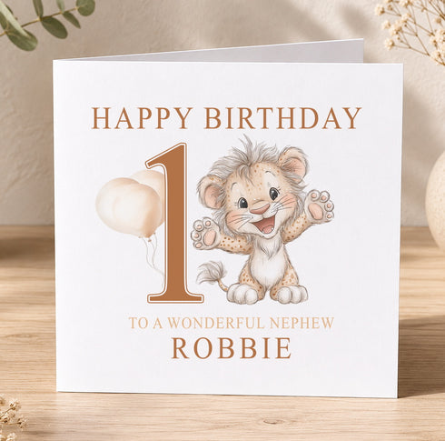 The image is a birthday card for a baby lion, with the text "Happy Birthday 1 to a wonderful nephew ROBBIE".