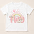 A white t-shirt with a pink unicorn and a rainbow graphic, along with the text "Hollie is two".