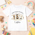 White children’s T-shirt with a personalised gold 2026 teddy bear preschool graduation design, child’s name and nursery name on a colourful classroom background.