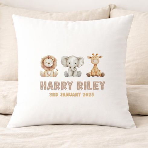 A white pillow with a personalized message and illustrations of a lion, elephant, and giraffe.