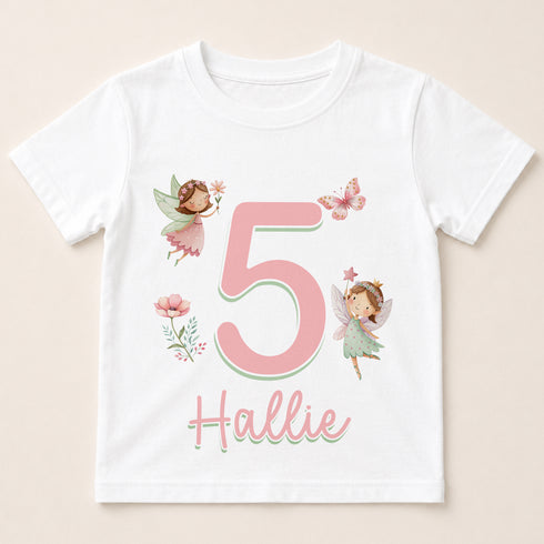 A white t-shirt with a pink number 5 and two fairy characters, along with the text "5 Hallie" printed on it.