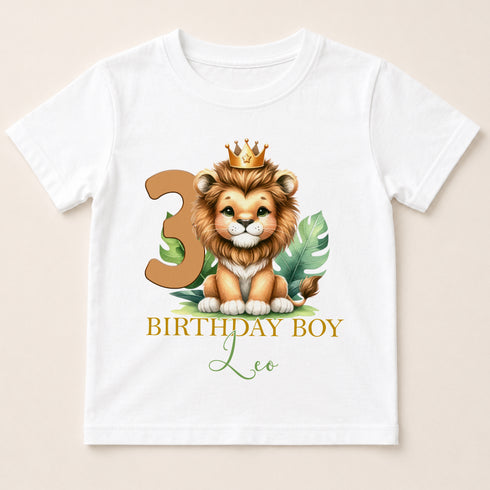 A white t-shirt with a cartoon image of a lion wearing a crown and the number 3, along with the text "BIRTHDAY BOY Leo".