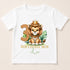 A white t-shirt with a cartoon image of a lion wearing a crown and the number 3, along with the text "BIRTHDAY BOY Leo".