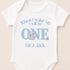 A white baby onesie with a blue elephant and text that says "When I wake up I will be one, Luca Jack".
