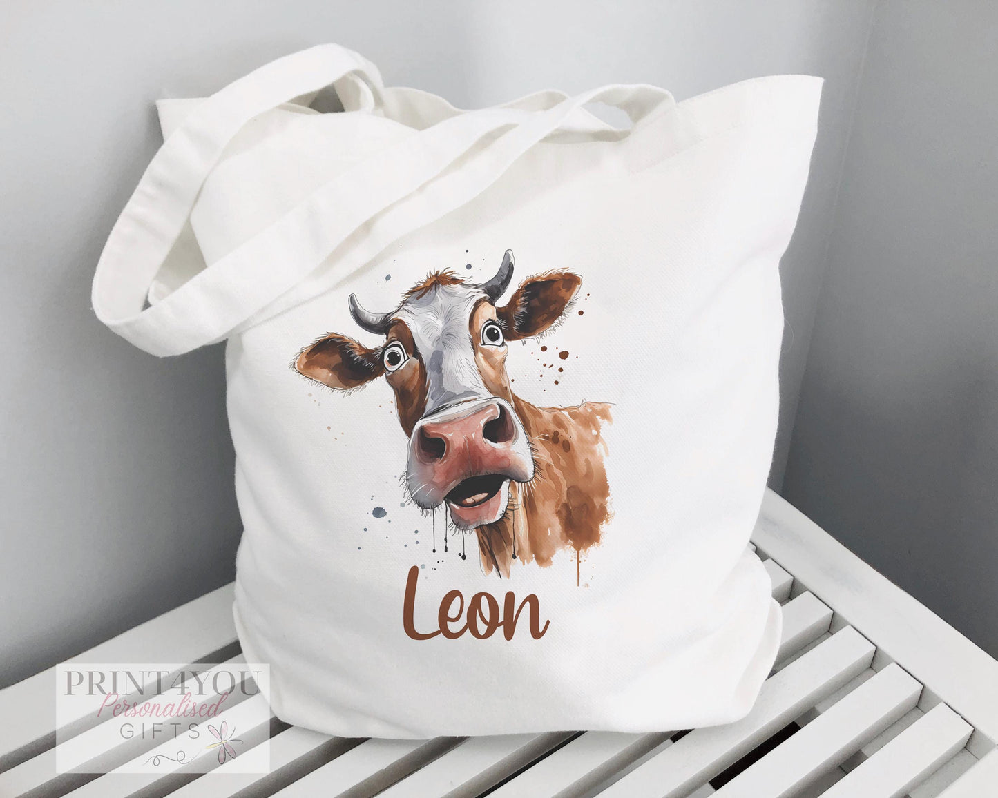 White cotton tote bag printed with a wide-eyed, shocked Highland Cow design