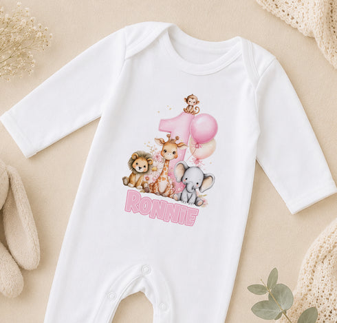 A white onesie with a cartoon image of animals and the name "Ronnie" printed on it, along with a pink balloon.