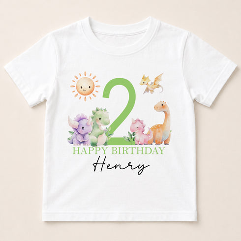 A white t-shirt with a graphic design featuring a sun, a dragon, and various animals, along with the text "Happy Birthday Henry".