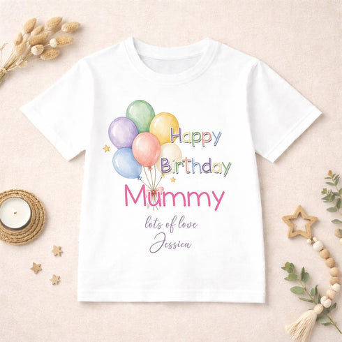 Personalised Happy Birthday Mummy children's white t-shirt with colourful balloon design and custom message displayed on a neutral styled background