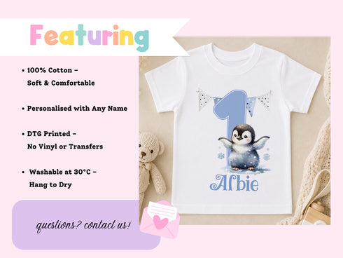 a white t-shirt with a penguin graphic and the number 1, along with a stuffed teddy bear and some text.