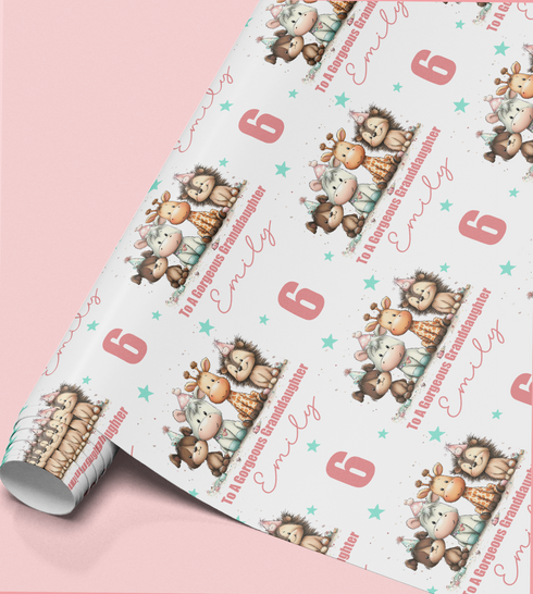 a roll of wrapping paper with a repeating pattern of cartoon animal characters, including giraffes, elephants, and zebras, along with the text "To A Gorgeous Granddaughter Emily" printed on it.