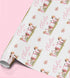 The image is a roll of wrapping paper with a repeating pattern of pink flowers and the text "Ella is" printed on it.