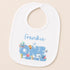 A white baby bib with a personalized message and illustrations of sea creatures.