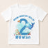 A white t-shirt with a design featuring a blue whale, a turtle, and other marine life, along with the text "When I wake up I will be 2 Rowan".
