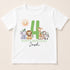 A white t-shirt with a graphic design featuring a large number 4 surrounded by various animals, including a lion, giraffe, zebra, and elephant. The text below the graphic reads "HAPPY BIRTHDAY Josh".