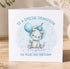 A birthday card with a cute illustration of a baby dinosaur wearing a party hat and holding a blue balloon, along with the text "To a special grandfather on your 2nd birthday".