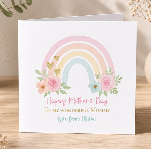 A white card with a colorful rainbow graphic and floral elements, along with a message that reads "Happy Mother's Day To my wonderful mummy Love from Olivia".