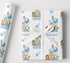 a gift wrapped in a white paper with a blue and white animal print, including elephants, giraffes, and lions. The paper has a white ribbon tied around it, and the name "RONNIE" is written on it.
