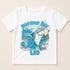 A white t-shirt with a graphic design featuring a shark and the number 5, along with the text "Birthday Boy Leo" and "5".