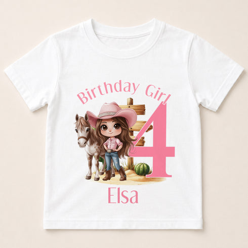 A white t-shirt with a graphic design featuring a cartoon image of a young girl wearing a cowboy hat and standing next to a horse, along with the text "Birthday Girl 4" and "Elisa" printed on it.