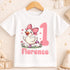 A white t-shirt with a cartoon image of a duck wearing a pink bow and surrounded by flowers, with the number 1 and the name "Florence" printed on it.