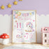 Personalised unicorn baby birth stats poster with pastel balloons, rainbow details, baby name, date, time, length and weight, shown framed in a nursery.