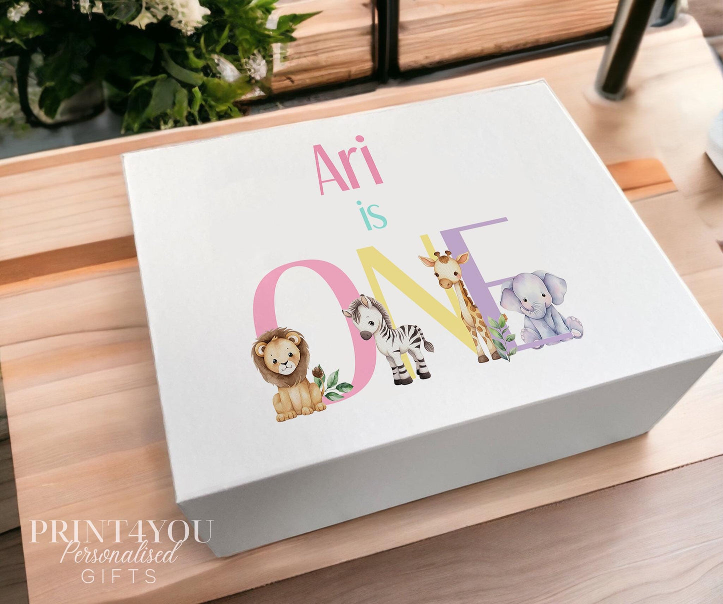 White magnetic-close keepsake box for a baby's first birthday, personalised with the child's name and printed with a pastel safari animal design, shown in the medium 160 x 200 x 80mm size