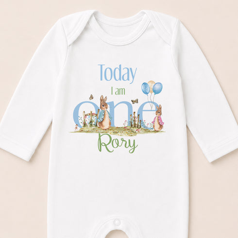 A white onesie with a personalized text and illustrations on it.