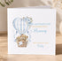 A greeting card with a mother and baby teddy bear illustration, along with a hot air balloon and floral design. The card has a message that reads "Happy Mother's Day to my beautiful Mummy with lots of love Finley".