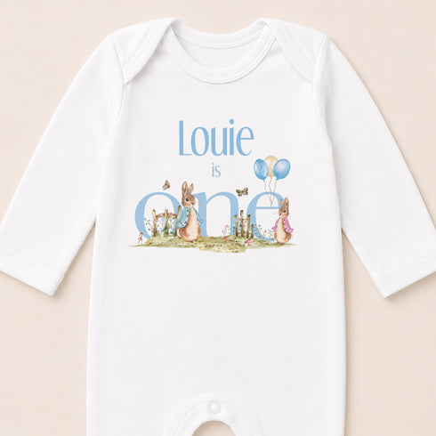 A white onesie with a personalized text and illustrations on it.