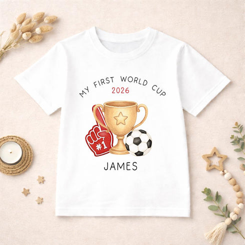 Personalised My First World Cup 2026 children’s t-shirt with football trophy and foam finger design, custom football shirt