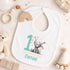 Personalised 1st birthday baby outfit with cute elephant, party hat, stars, teal number 1 and custom name, shown on bib, vest, sleepsuit, t-shirt and white pyjamas.