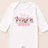 A white baby onesie with the text "Indie's FIRST RODEO" printed on it.