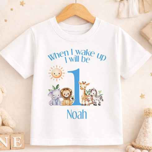 A white t-shirt with a personalized design featuring a sun and various animals, along with the text "When I wake up I will be Noah".