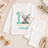 Personalised 1st birthday baby outfit with cute elephant, party hat, stars, teal number 1 and custom name, shown on bib, vest, sleepsuit, t-shirt and white pyjamas.