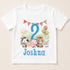 A white t-shirt with a cartoon image of various animals, including a horse, cow, pig, sheep, and a sun, along with a number 2 and the name " Joshua" printed on it.