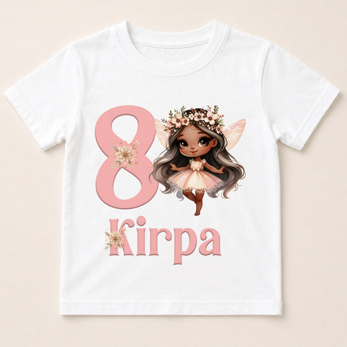 A white t-shirt with a graphic design featuring a fairy-like character and the number 8, along with the text "Kirpa" below the number.