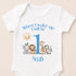 A white baby onesie with a printed design of various animals, including a lion, giraffe, elephant, and zebra, along with the text "When I wake up I will be Noah".