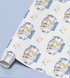 The image is a roll of wrapping paper with a repeating pattern of a boy wearing a spacesuit and the number "2" on it, along with stars and clouds.