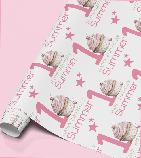 a roll of wrapping paper with a repeating pattern of pink cupcakes and stars, along with the text "Happy Summer 1st Birthday".